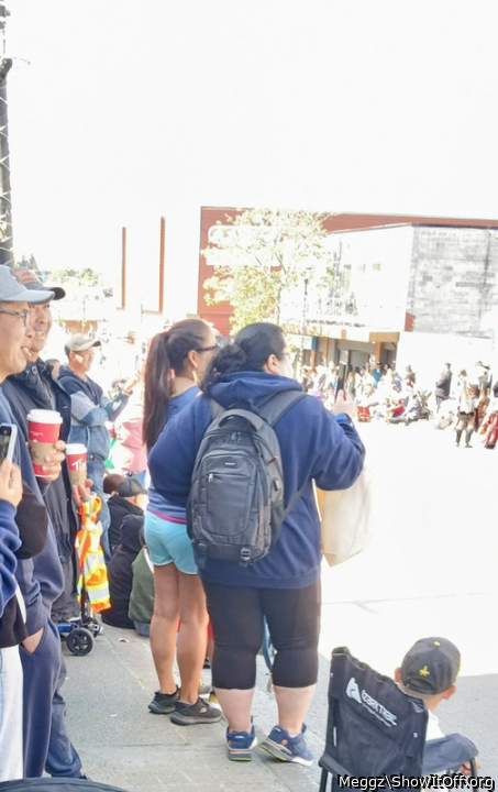 my brother in-law taking pics of me at the parade like my leggings?