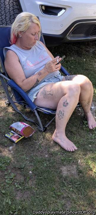 While you watch your phone I'll stroke my cock between your 