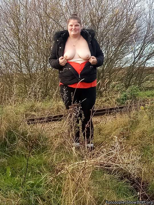 Outdoor showing of her tits.